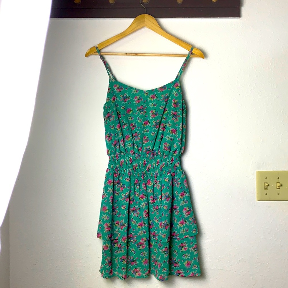 Green dress with floral print and cinched in waist